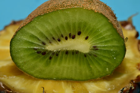 Kiwi fruit on a blue background, close-up.の写真素材
