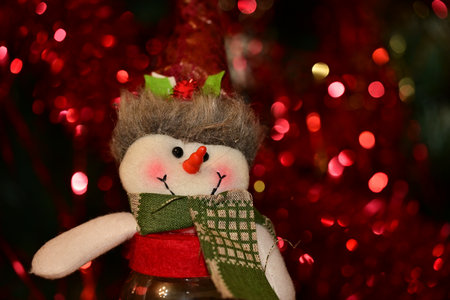 Christmas decoration with snowman and bokeh lights on background.