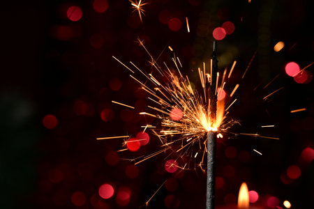 Burning sparkler on bokeh background, Christmas and New Year conceptの写真素材