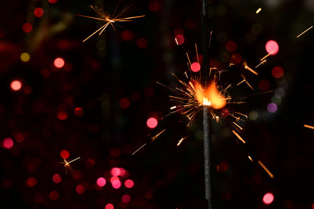 Burning sparkler on bokeh background, Christmas and New Year conceptの写真素材
