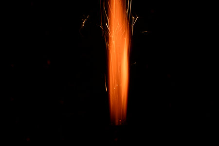 sparks from a welding torch on a black background close-up