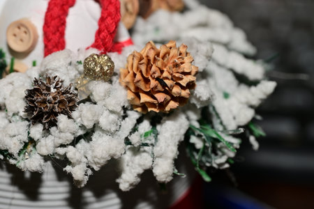Christmas decoration with pine cones and snowflakes on blurred background.の写真素材