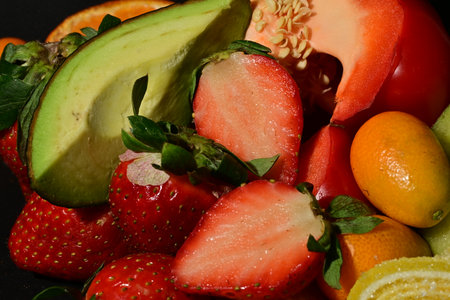 Fruit salad with strawberries, oranges, lemons and avocado.の写真素材