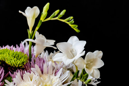 beautiful bouquet of flowers on a black background close-upの写真素材