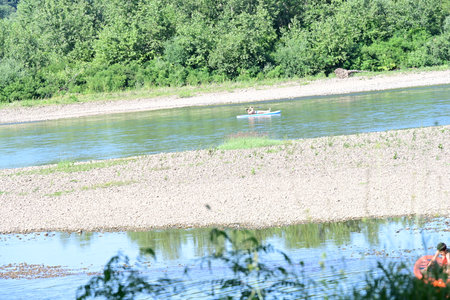 Summer landscape with river and people on kayak on a sunny dayの写真素材