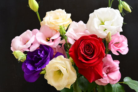 Bouquet of colorful flowers on black background.
