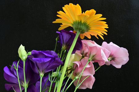 bouquet of eustoma and lisianthus on black background