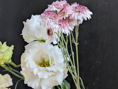 Bouquet of white and pink flowers on black backgroundの写真素材
