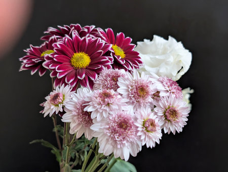 Bouquet of pink and white flowers on black background