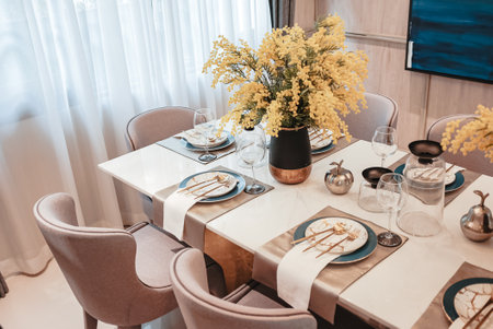 This elegant black granite dining table comes complete with a complete set of crockery, goblets and wine glasses.の写真素材