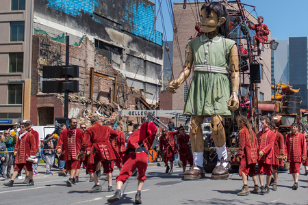 Montreal, Canada - May 20, 2017: The Little Girl-Giant presented by Royal de Luxe takes a walk on Viger Avenue to celebrate the 375th birthday of the city.のeditorial素材