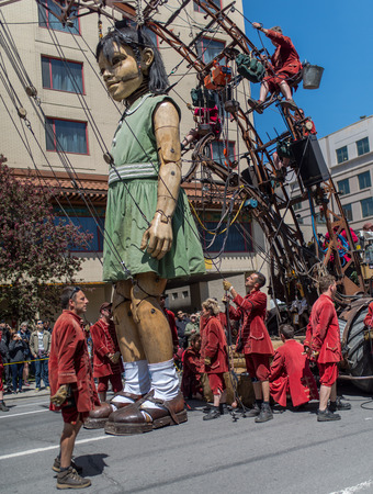 Montreal, Canada - May 20, 2017: The Little Girl-Giant presented by Royal de Luxe takes a walk on Viger Avenue to celebrate the 375th birthday of the city.のeditorial素材