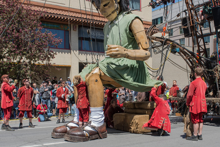 Montreal, Canada - May 20, 2017: The Little Girl-Giant presented by Royal de Luxe takes a walk on Viger Avenue to celebrate the 375th birthday of the city.のeditorial素材