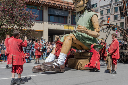 Montreal, Canada - May 20, 2017: The Little Girl-Giant presented by Royal de Luxe takes a walk on Viger Avenue to celebrate the 375th birthday of the city.のeditorial素材