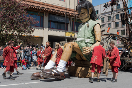 Montreal, Canada - May 20, 2017: The Little Girl-Giant presented by Royal de Luxe takes a walk on Viger Avenue to celebrate the 375th birthday of the city.のeditorial素材