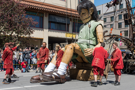 Montreal, Canada - May 20, 2017: The Little Girl-Giant presented by Royal de Luxe takes a walk on Viger Avenue to celebrate the 375th birthday of the city.のeditorial素材