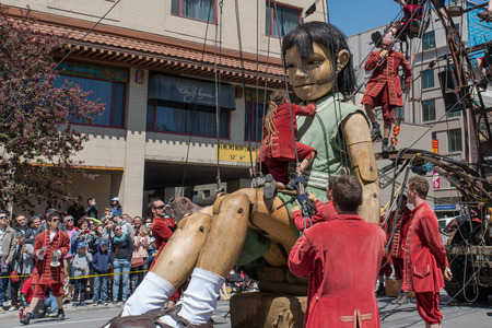Montreal, Canada - May 20, 2017: The Little Girl-Giant presented by Royal de Luxe takes a walk on Viger Avenue to celebrate the 375th birthday of the city.のeditorial素材