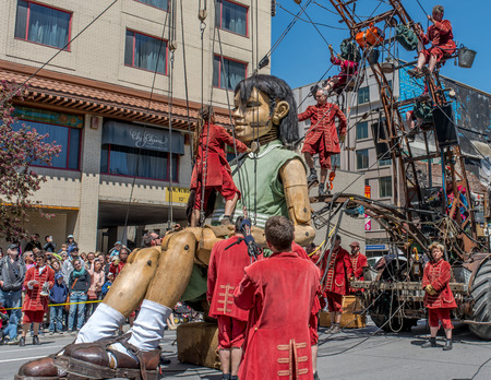 Montreal, Canada - May 20, 2017: The Little Girl-Giant presented by Royal de Luxe takes a walk on Viger Avenue to celebrate the 375th birthday of the city.のeditorial素材