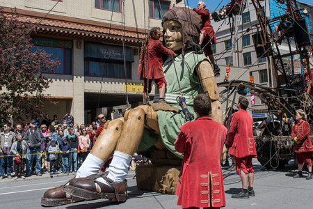 Montreal, Canada - May 20, 2017: The Little Girl-Giant presented by Royal de Luxe takes a walk on Viger Avenue to celebrate the 375th birthday of the city.のeditorial素材