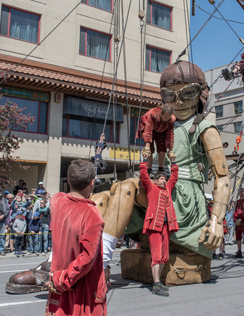 Montreal, Canada - May 20, 2017: The Little Girl-Giant presented by Royal de Luxe takes a walk on Viger Avenue to celebrate the 375th birthday of the city.のeditorial素材