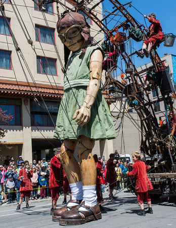 Montreal, Canada - May 20, 2017: The Little Girl-Giant presented by Royal de Luxe takes a walk on Viger Avenue to celebrate the 375th birthday of the city.のeditorial素材