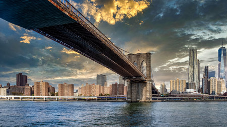 Brooklyn Bridge and Manhattan skyline at sunset, New York City.