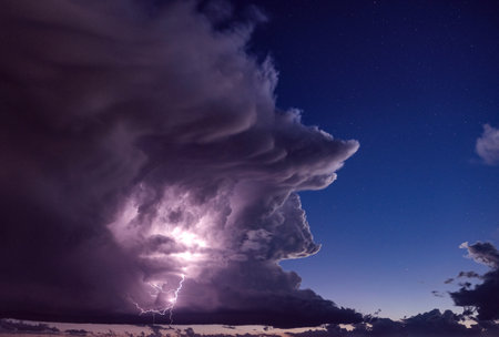 Lightning in the night sky. Thunderstorm in the night sky.