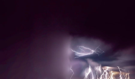 Lightning in the night sky. Thunderstorm. Abstract background.の写真素材
