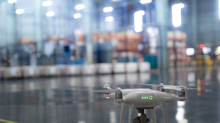 Smart factory with Drone camera surveying a industrial facility enabling IOT, tracking goods and inventory, logistic mapping in a futuristic world.の写真素材