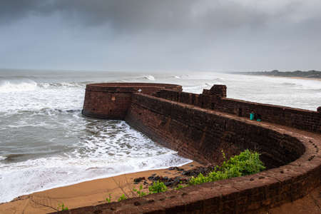 Old ruins of Fort Aguada on the seashores of Goa with sky and cloudsの写真素材