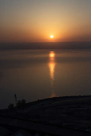 Dramatic Portait view of Early Sunrise over the sea of Galilee in Israelの写真素材