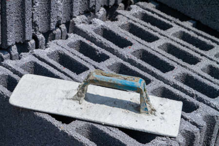 Plastering Float on Aerated bricks pile in construction area, preparing cement for cement wall construction. Brick that water can penetrate. Plastering equipment. Smoothness.の写真素材