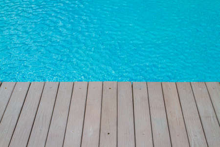 Artificial wood balcony, The gray-colored modeled shera partition board beside the pool with a...