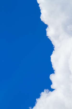 Gray dense clouds With a dark blue background With a cloud in the left corner of the image.の写真素材