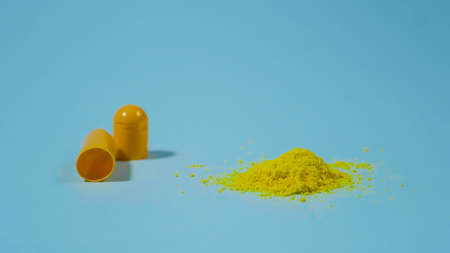Powder of pills. Yellow medicine from a capsule. Pharmaceutical Concept.の写真素材
