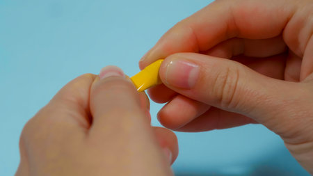 close up hand opening medicine capsule pill.の写真素材