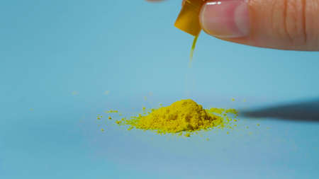 Powder of pills. Yellow medicine from a capsule. Pharmaceutical Concept.の写真素材