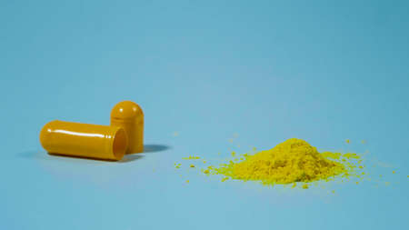Powder of pills. Yellow medicine from a capsule. Pharmaceutical Concept.の写真素材