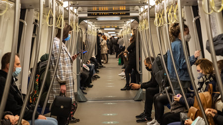 BUCHAREST, ROMANIA - May 15, 2021: Subway during Coronavirus crisis. People wearing masks at train interior during covid-19, spring 2021, People on the subway with phones in hand. Metro train public transportation.のeditorial素材