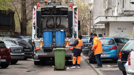 BUCHAREST, ROMANIA - May 15, 2021: White Garbage truck used for Collection of waste or garbage in Bucuresti. Garbage men operating garbage truck, solid household waste collectionのeditorial素材