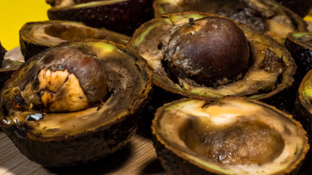 Close up Bad Avocado. Ugly Tropical fruits. Contaminated Avocado halfs. Necomestibile Fruits. Details Overripe Avocado. Unhelthy food Concept.の写真素材