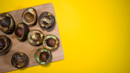 sliced unhealthy rotten avocados on old gray tableの写真素材