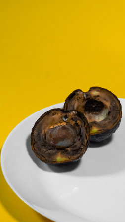 Avocado cut in half moldy Close up Vertical Photo. Ugly Tropical fruits. Contaminated Food Necomestibile Fruits. Vegan food. Overripe Avocado.の写真素材