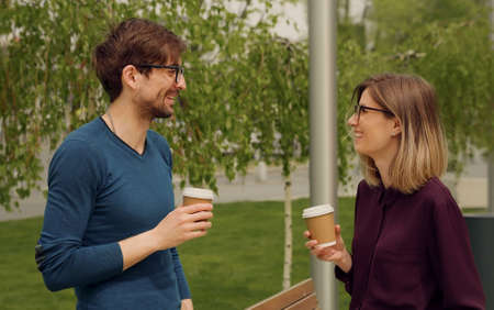 Smiling caucasian businesswoman and man Funny Coversation talking. Coworkers friendly discussion...