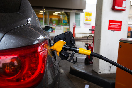 Refueling refilling car vehicle with fuel at refuel fuel gas pump station - Petrol diesel gas pump...