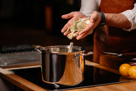 Prepping celery on cutting board ingredients in a large kitchenの写真素材