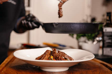 Beef Meat and Vegetables Plate. Fried Corn Green Beans. Food on a White Plate in Restaurant.の写真素材
