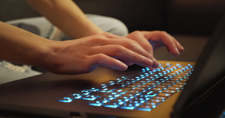 Hands typing on Keyboard Late Night Working.の写真素材