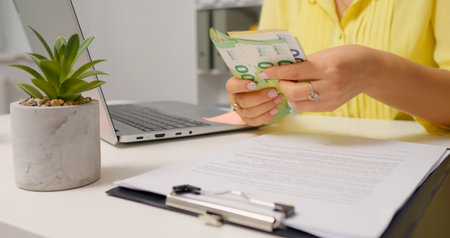 Woman counting euro cash above the clipboard. Investment money saving for future. Money concept.の写真素材
