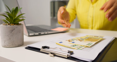 Opening a clipboard woman hands counting bill for payday. Money investing in assets by business...